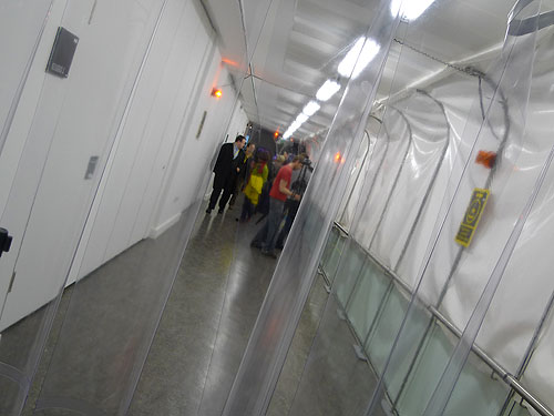 The tunnel contains alarm effects triggered by sentinel tags and disinfection stations.